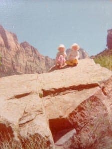 My sister and I on the rock in front of our house. I am on the right.